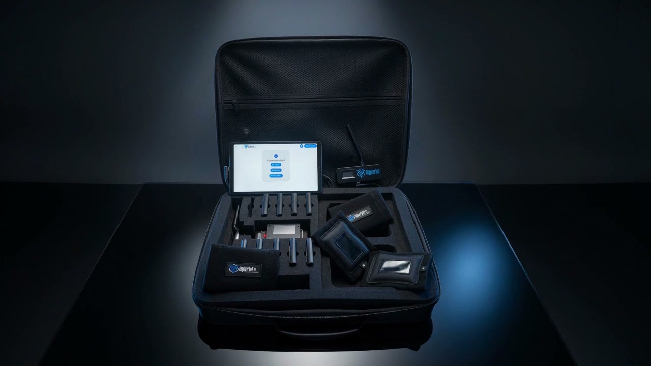 The full DigiWrist kit open in its case: coach tablet, encrypted transmitter, wrist receivers and armbands